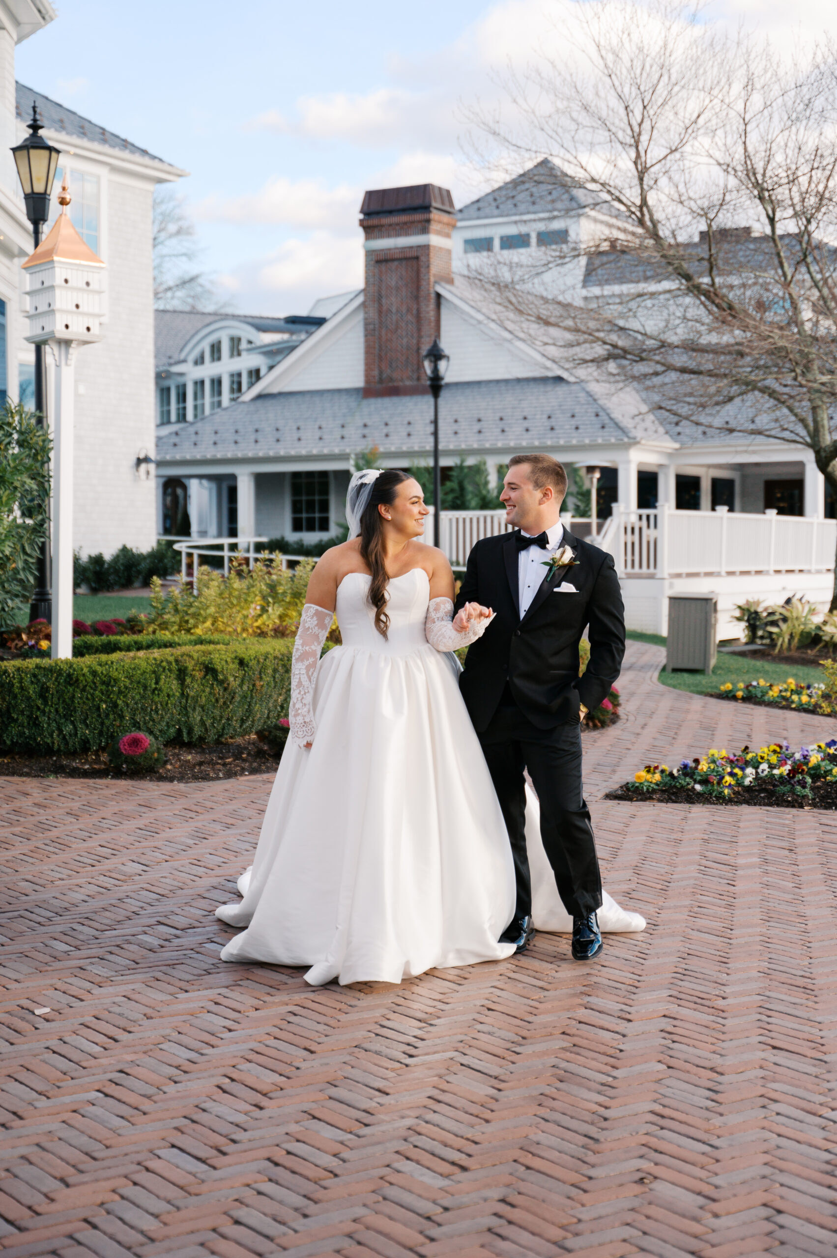 Bride and groom walking on the grounds of the Mill Lakeside Manor before getting married. They are with their New Jersey Wedding Photographer.